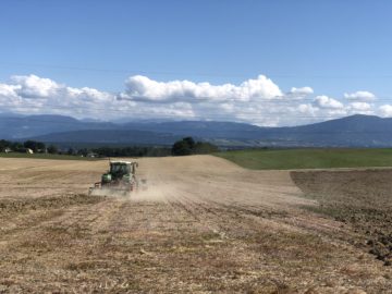 A Tractor Ploughing A Dry Field in Switzerland