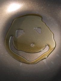 A smiley face made of oil