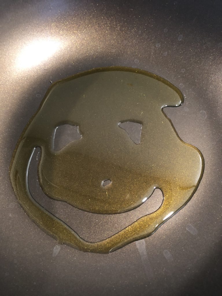A smiley face made of oil