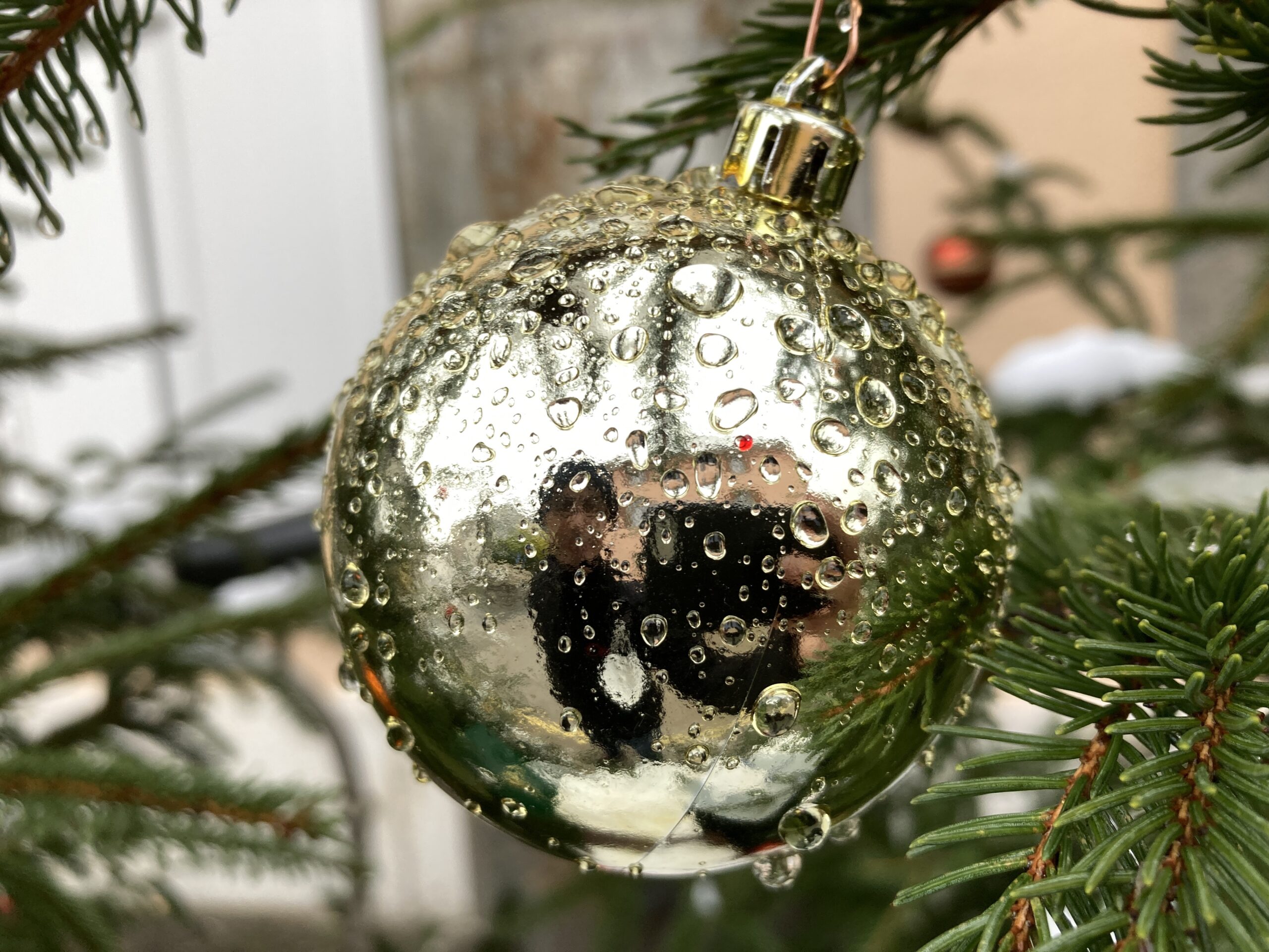 A picture of me, reflected in a Christmas decoration