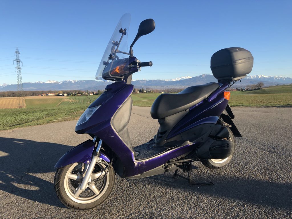 The scooter near Nyon, with the Alps in the background