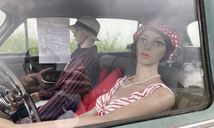 Two mannequins in a classic american car