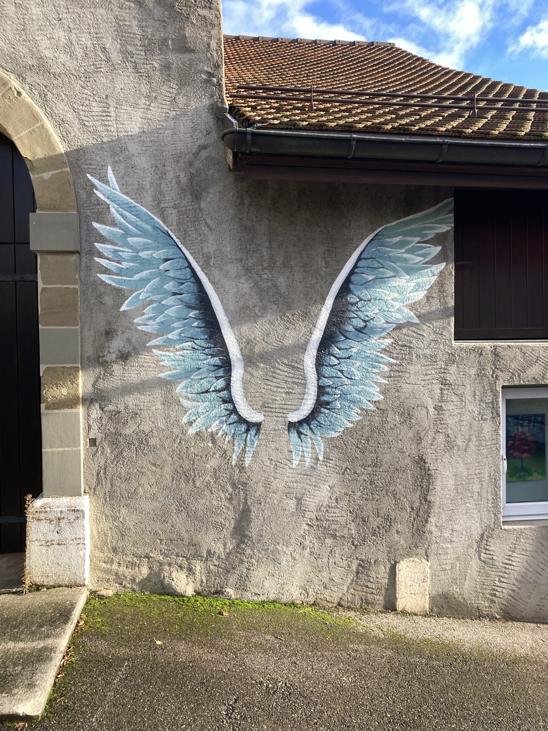 Angel wings painted on a wall. You could stand and be pictured with angel wings.