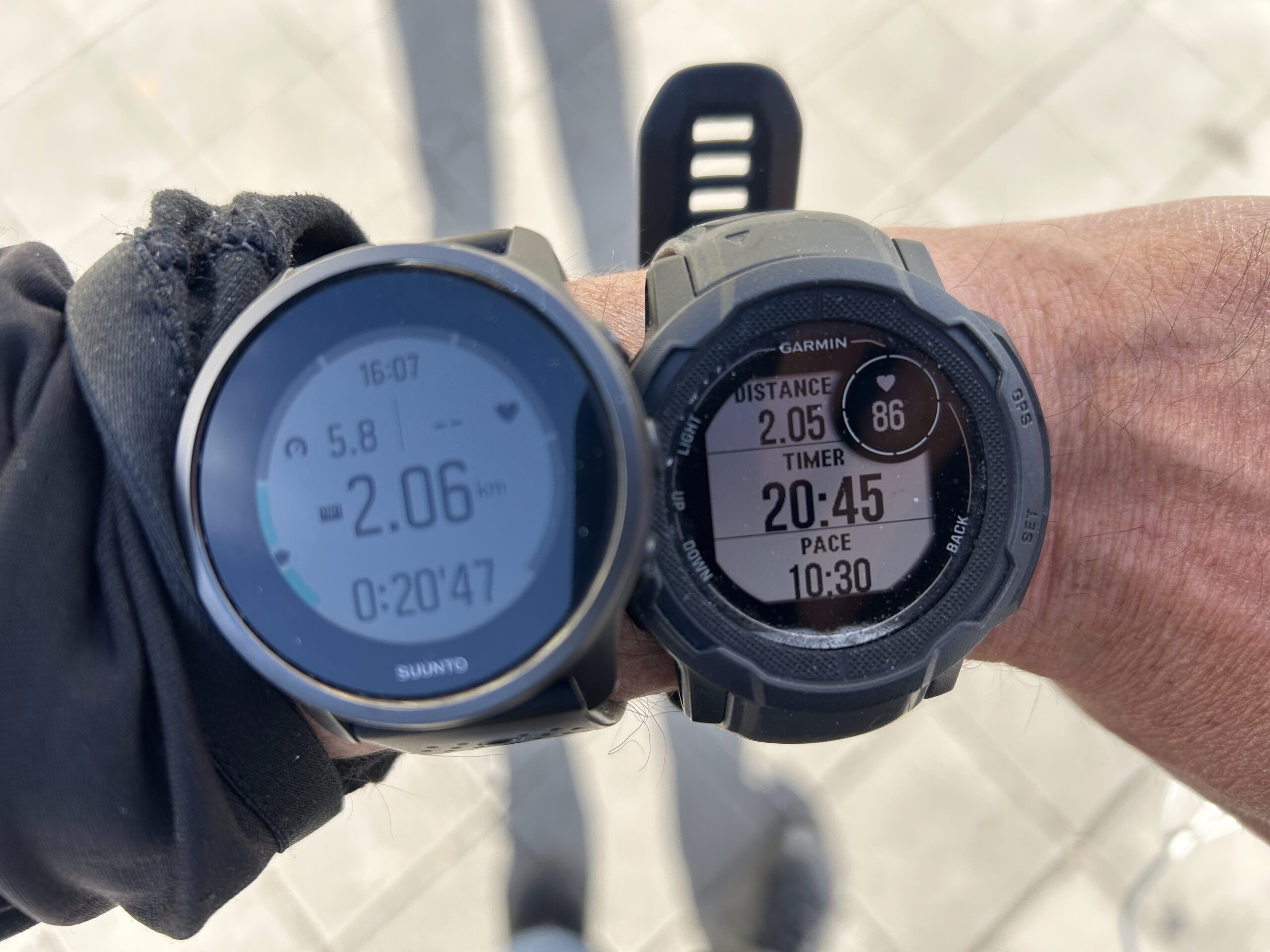 A Garmin Instinct 2 and a Suunto Peak 5 tracking a walk