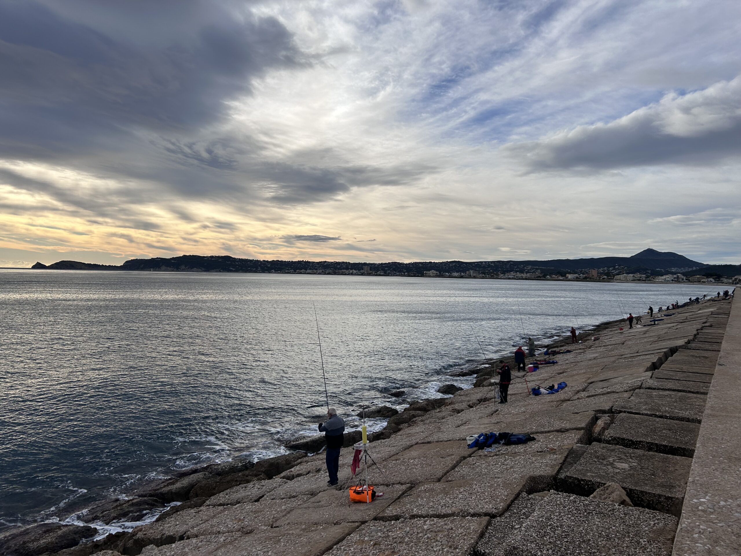 People fishing by the Mediterranean